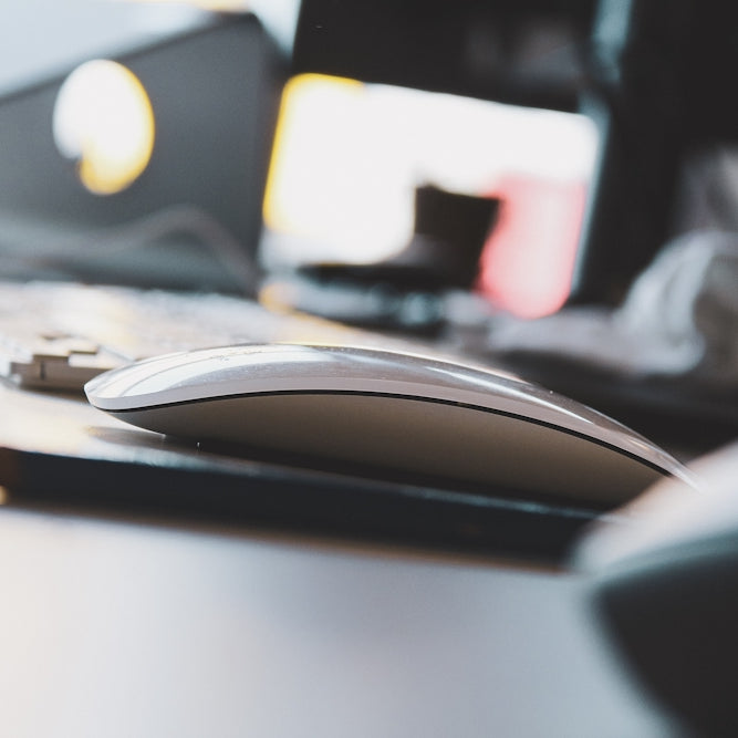 black and yellow computer mouse on white desk