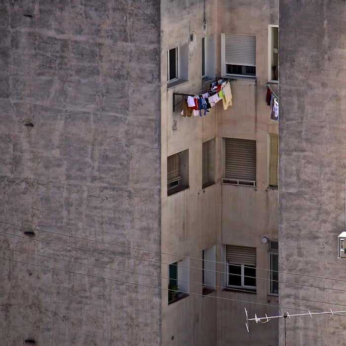 an apartment building with clothes hanging out of the windows