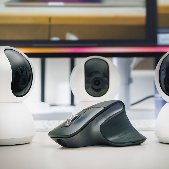 A group of three cameras sitting on top of a table